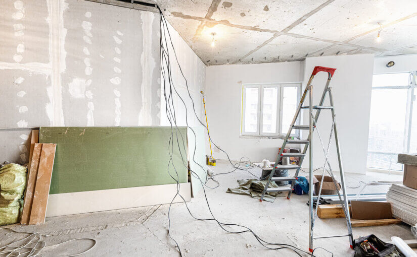 Working process of renovate room with installing drywall or gypsum plasterboard and ladder with construction materials are in apartment is under construction, remodeling, renovation, extension, restoration and reconstruction
