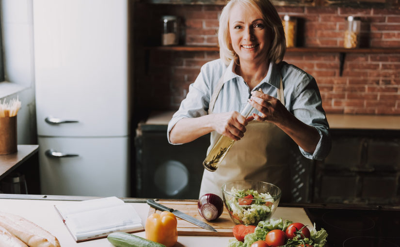Senior Woman Cooking Salad in Kitchen at Home. Grandma Cooking Food. Healthy Food Concept. Vegetable Salad. Diet. Dieting Concept. Healthy Lifestyle. Cooking At Home. Prepare Food