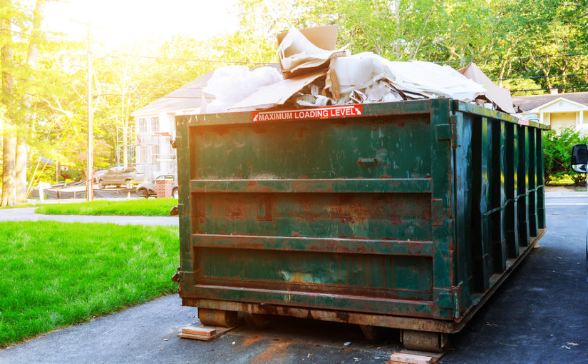 A commercial skip full to the rafters with rubbish.