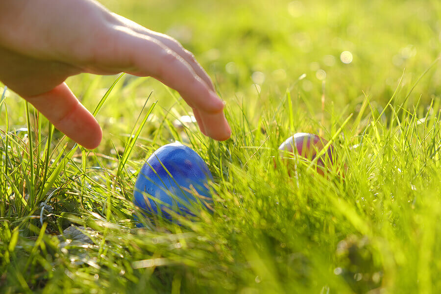 A child picks up vegan easter eggs.