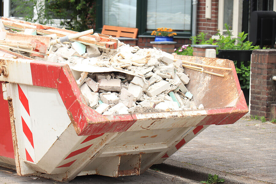 Loaded dumpster near a construction site, a home renovation or maintenance