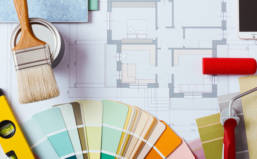 An image representing the concept of home renovation, featuring reno plans and equipment like paint and a paintbrush.